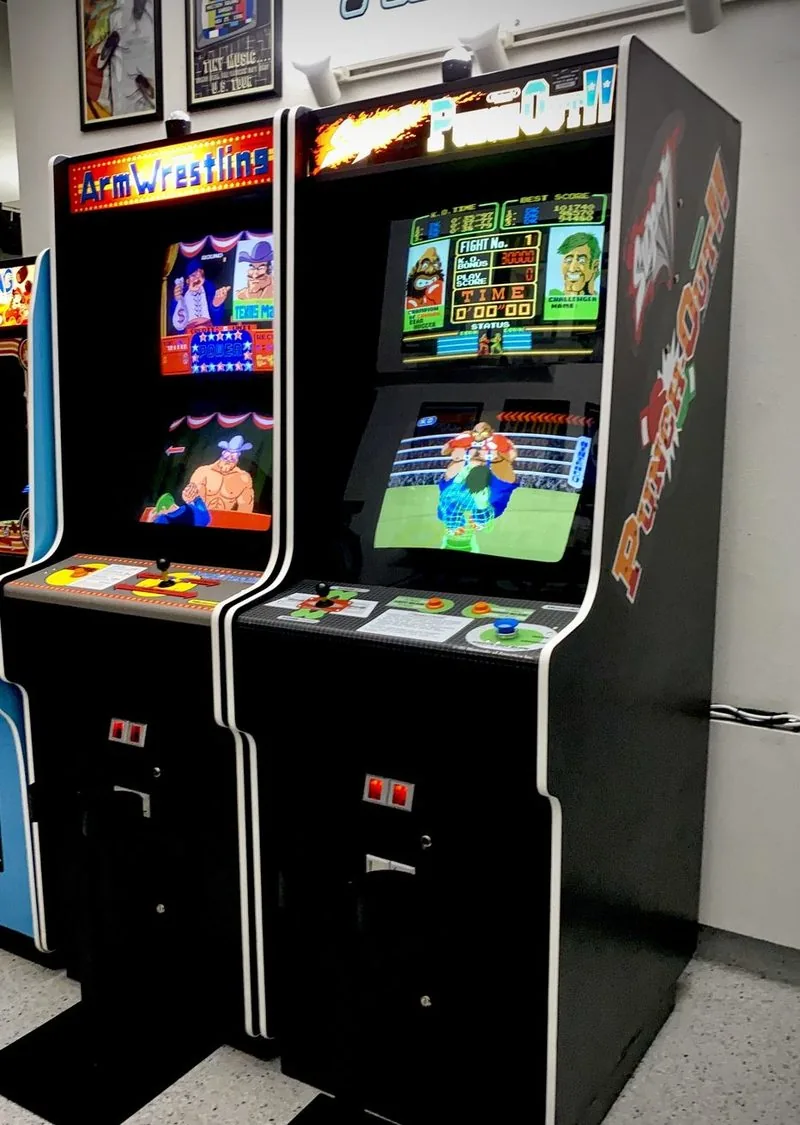 Nintendo Arm Wrestling and Super Punch-Out arcade cabinets side by side