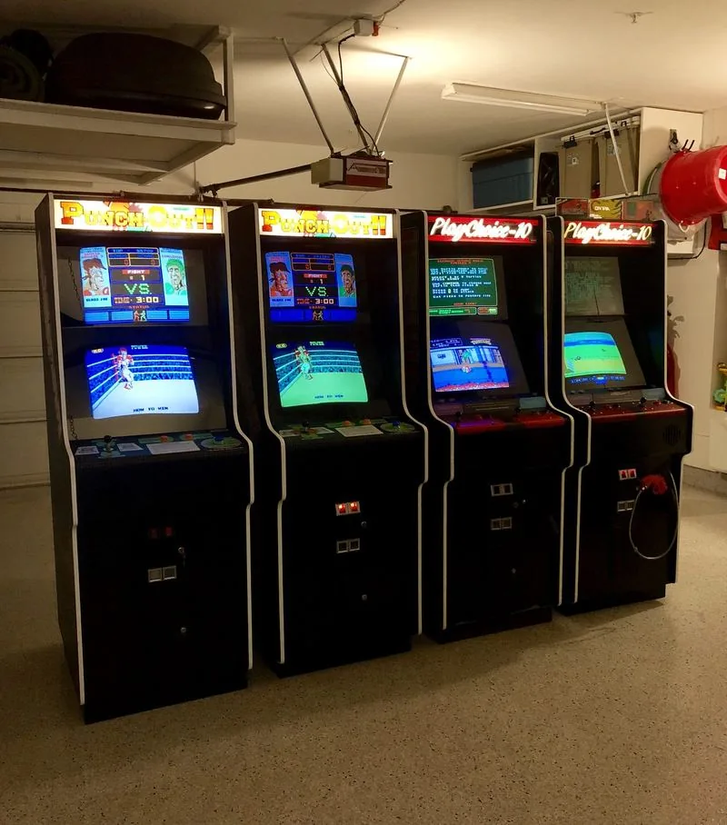 Two Punch-Out arcade cabinets and two PlayChoice-10 cabinets in a garage