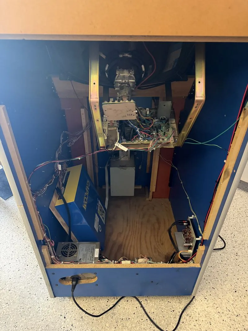 The Big Blue cabinet with its back panel removed, showing the monitor chassis, the Capcom board case, the power supply and the wiring loom