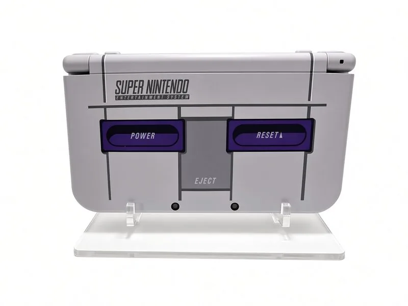 New Nintendo 3DS XL SNES Edition closed, showing the Super Nintendo styling with purple power and reset accents