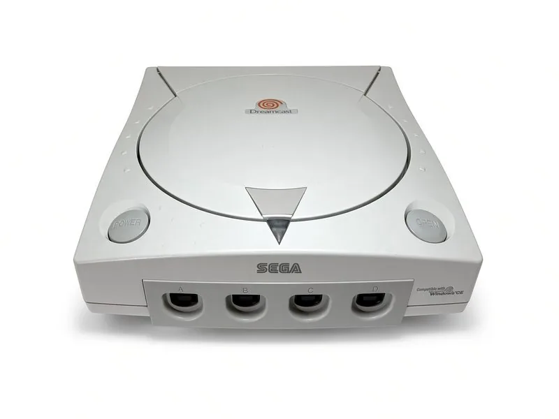 Sega Dreamcast seen from the front, swirl logo on the disc lid and four controller ports