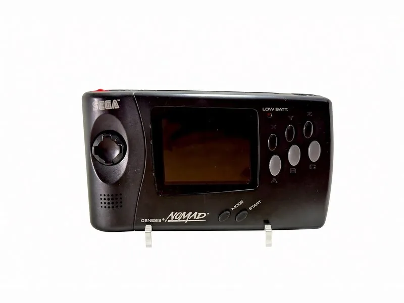 Sega Genesis Nomad handheld on a clear display stand, six-button face and screen forward