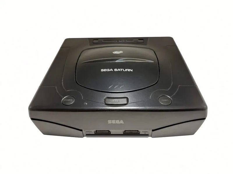 Sega Saturn seen from the front, disc lid closed and both controller ports visible