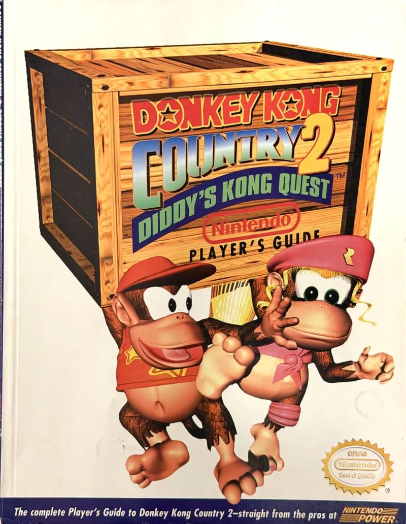 Cover of the Nintendo Player's Guide for Donkey Kong Country 2, Diddy and Dixie Kong beside a wooden crate