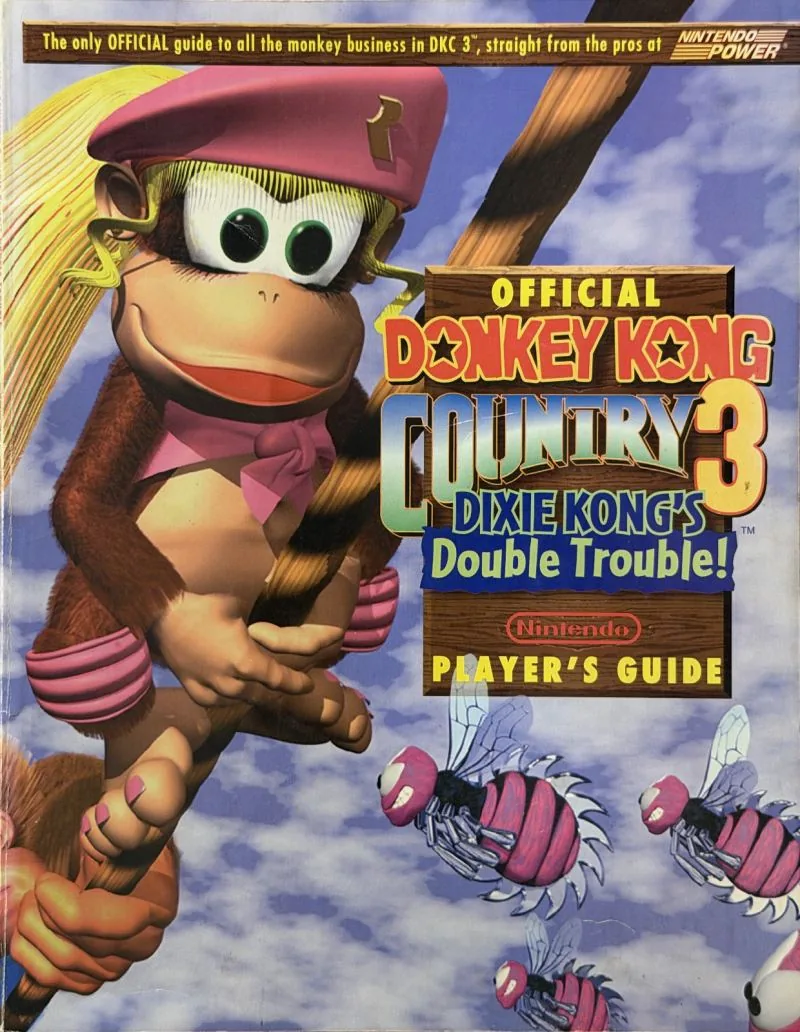 Cover of the Nintendo Player's Guide for Donkey Kong Country 3, Dixie Kong in a pink beret above the clouds