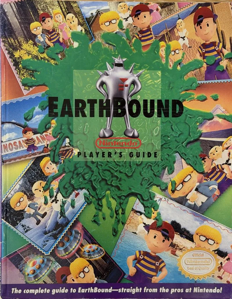 Cover of the Nintendo Player's Guide for EarthBound, clay figures around a splash of green