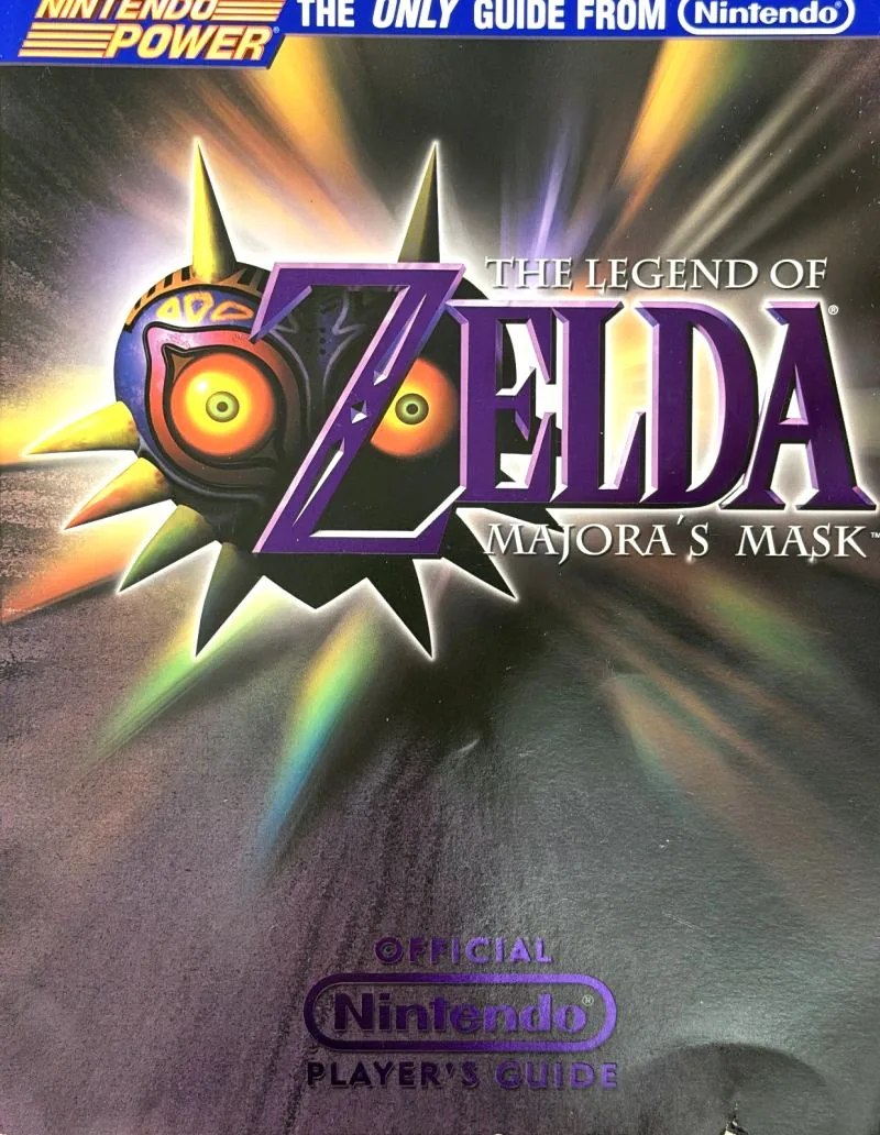Cover of the Nintendo Player's Guide for The Legend of Zelda: Majora's Mask, the mask on a burst of gold
