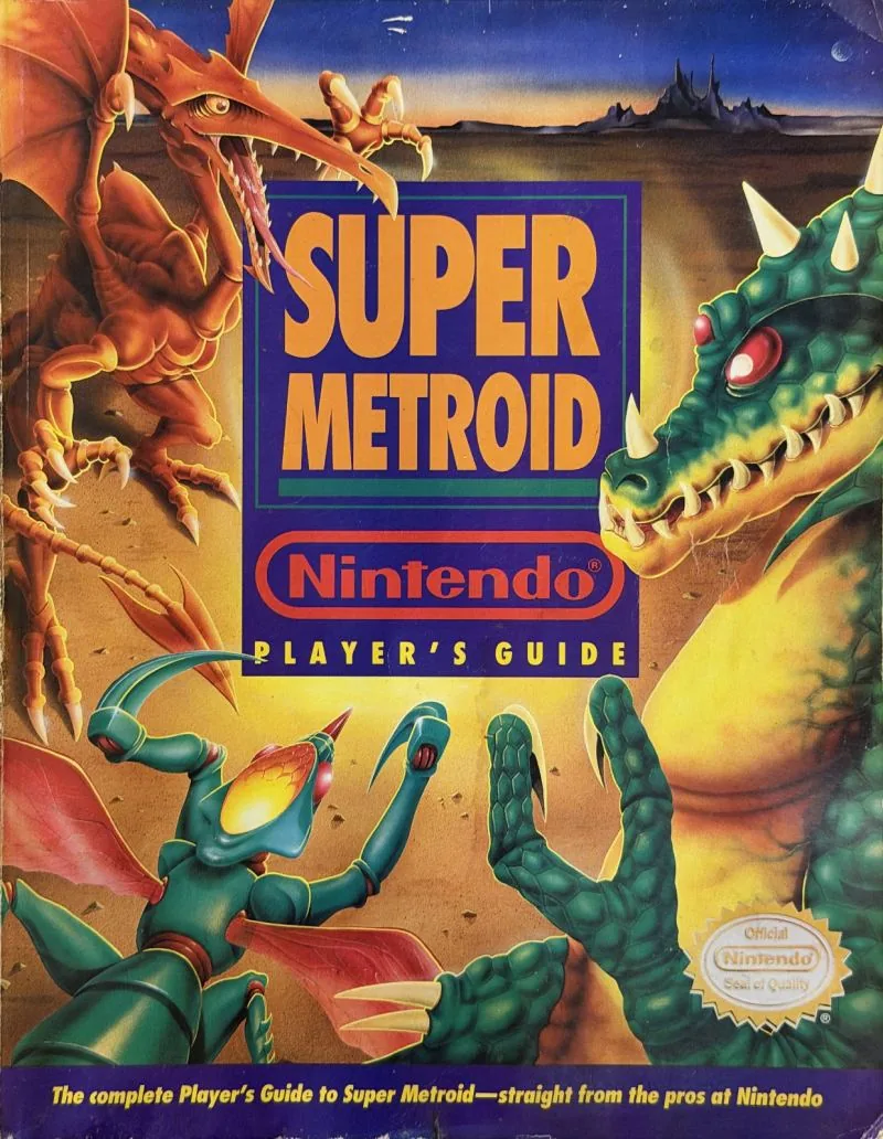 Cover of the Nintendo Player's Guide for Super Metroid, an orange dragon over desert with a green creature rising