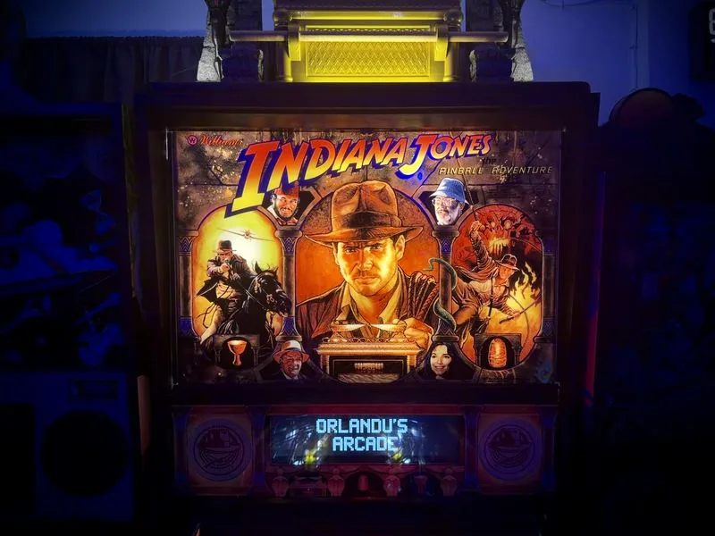 The Indiana Jones pinball translite showing Indiana Jones, Marion and the cast, lit from behind