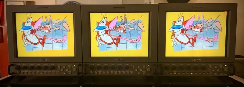 Three Sony LMD professional LCD monitors side by side, all showing the same cartoon frame