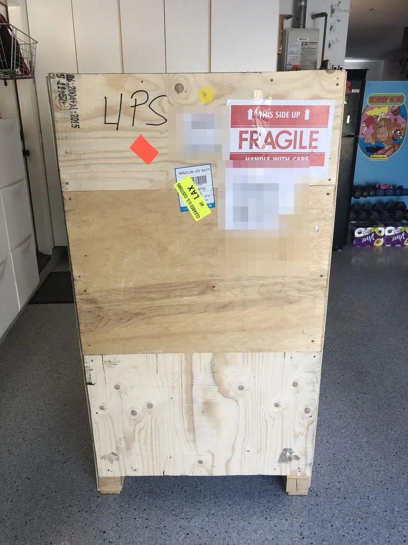 Crate side with FRAGILE sign, Norwegian Air Shuttle sticker, and a Cleared U.S. Customs at LAX sticker