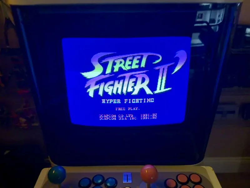 Close-up of the Mini Cute screen showing the Street Fighter II Hyper Fighting title with FREE PLAY below it