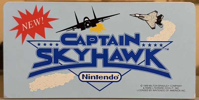 Original Nintendo PlayChoice-10 arcade topper for Captain Skyhawk, two jets over pale blue