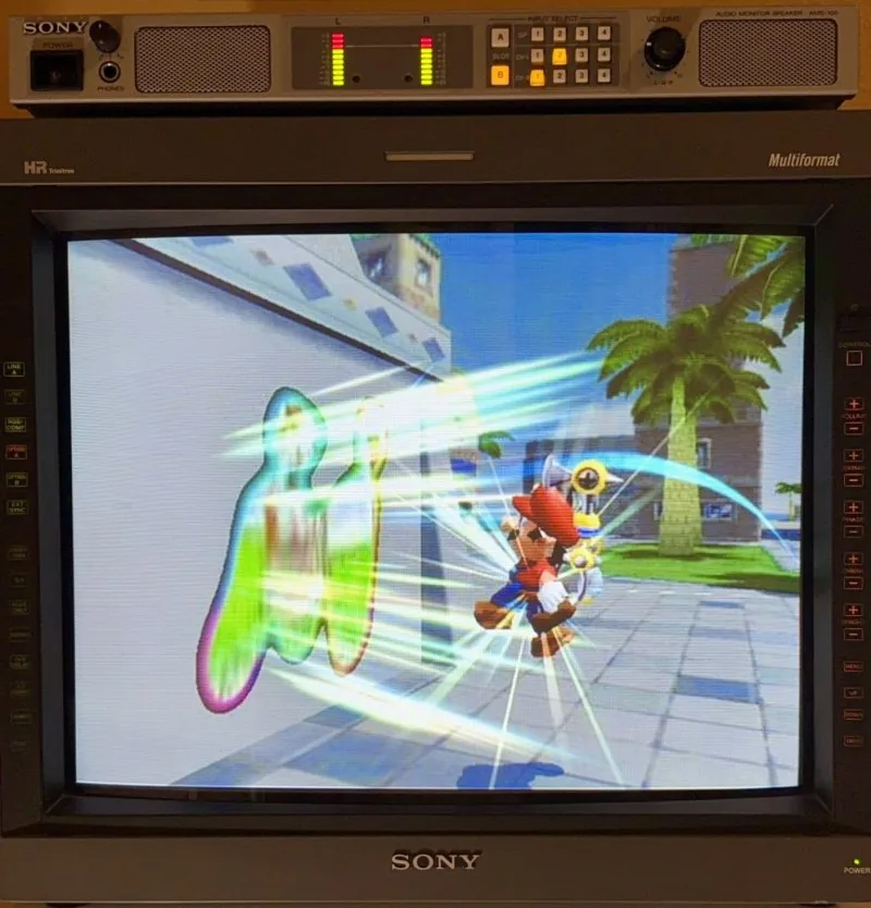 Sony PVM-20L5 multiformat Trinitron monitor lit and running Super Mario Sunshine, an AMS-100 audio monitor on top and both control strips in frame
