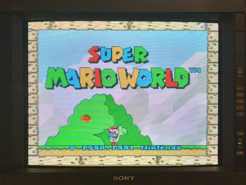 Sony PVM-2950Q 29-inch Trinitron production monitor lit at night running Super Mario World, its control panel and the SONY badge in frame