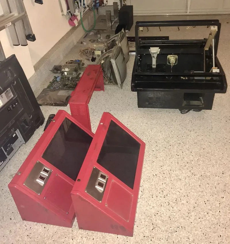 Red Tent completely disassembled: canopy shells on the garage floor, chassis stripped, monitor and boards laid out