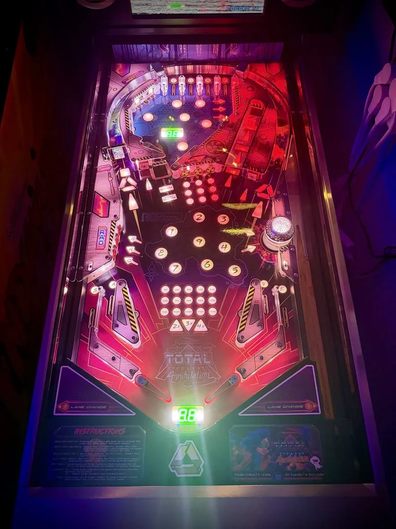 The Total Nuclear Annihilation playfield lit in red, showing the reactor targets and drop targets
