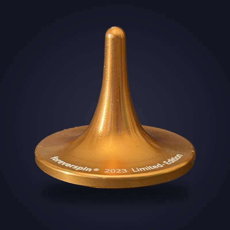 Foreverspin Amber Ore spinning top, 2023 limited edition, photographed off its base