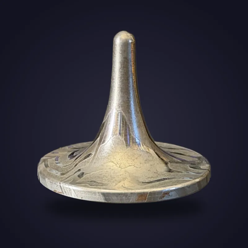 Foreverspin CarbonChromium spinning top, photographed off its base