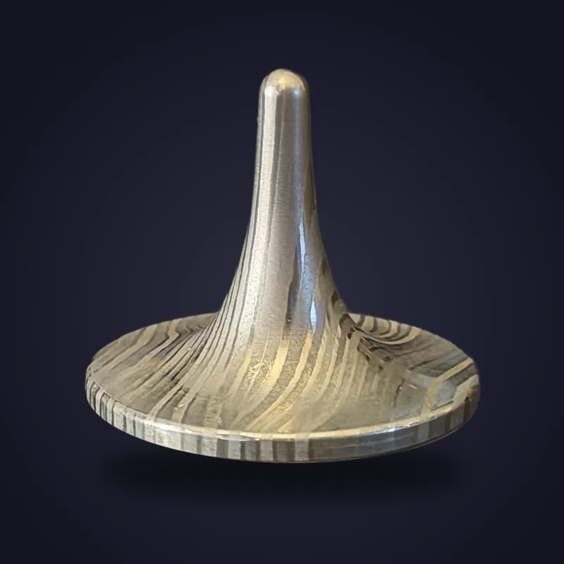 Foreverspin Damascus Steel spinning top, photographed off its base