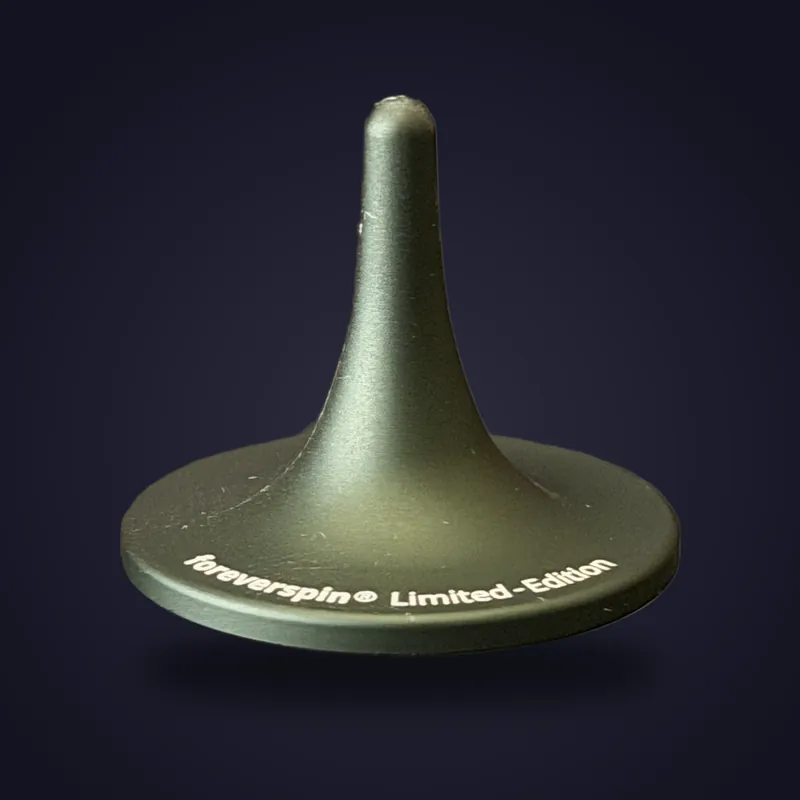 Foreverspin Dark Green spinning top, limited edition, photographed off its base