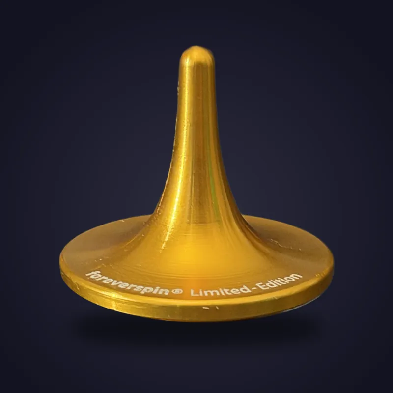 Foreverspin Gold spinning top, limited edition, photographed off its base