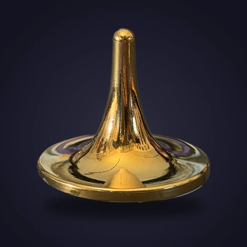 Foreverspin Golden-Inox spinning top, photographed off its base