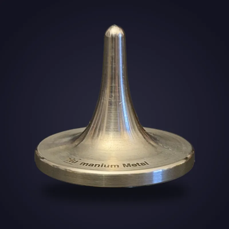 Foreverspin Humanium Metal (Engraved) spinning top, photographed off its base