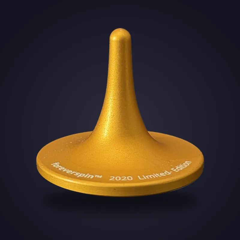 Foreverspin Inca Gold spinning top, 2020 limited edition, photographed off its base