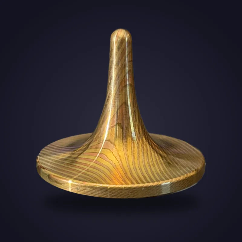 Foreverspin Red Gold Mokume-Gane spinning top, photographed off its base
