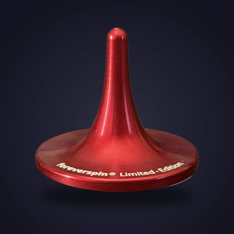 Foreverspin Red spinning top, limited edition, photographed off its base