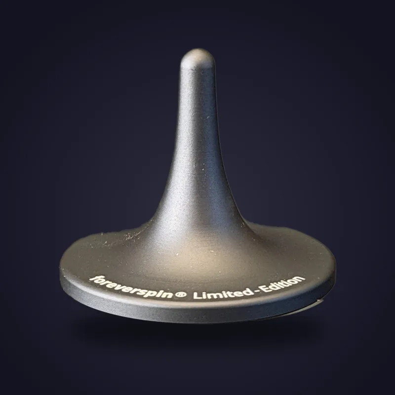 Foreverspin Space Gray spinning top, limited edition, photographed off its base