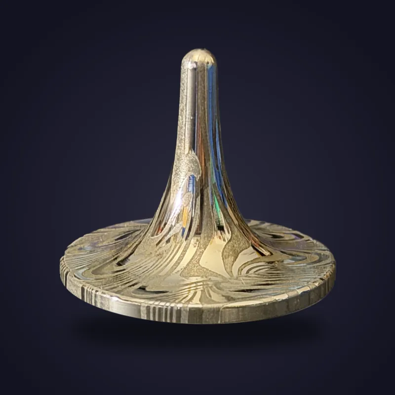 Foreverspin Stainless Steel Damascus spinning top, photographed off its base