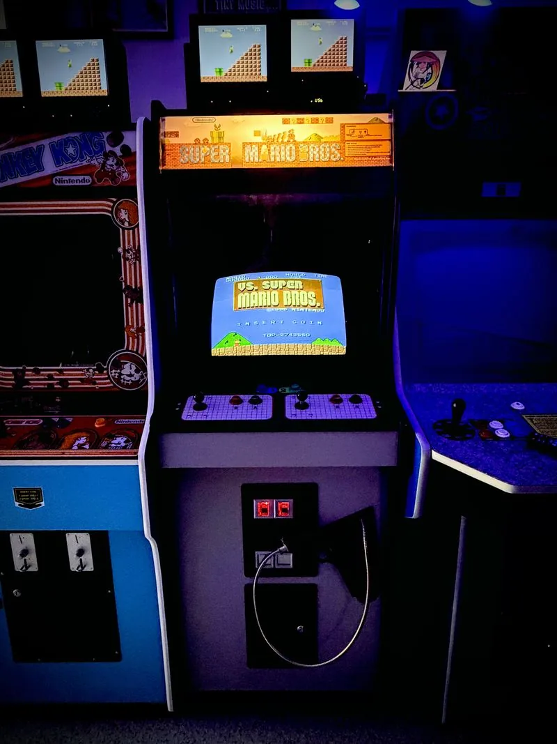 Nintendo VS. UniSystem dedicated arcade cabinet with the VS. Super Mario Bros. marquee lit