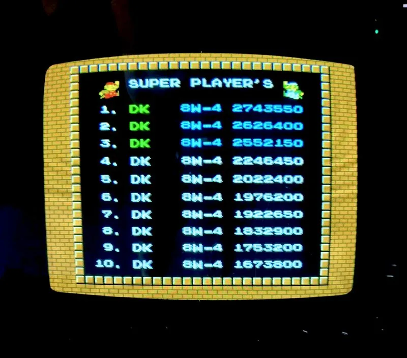 VS. Super Mario Bros. Super Player's high score table, all ten entries initialed DK, all reaching world 8-4