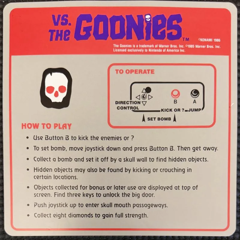 Nintendo VS. The Goonies instruction card, red and white, with a skull illustration and how to play list