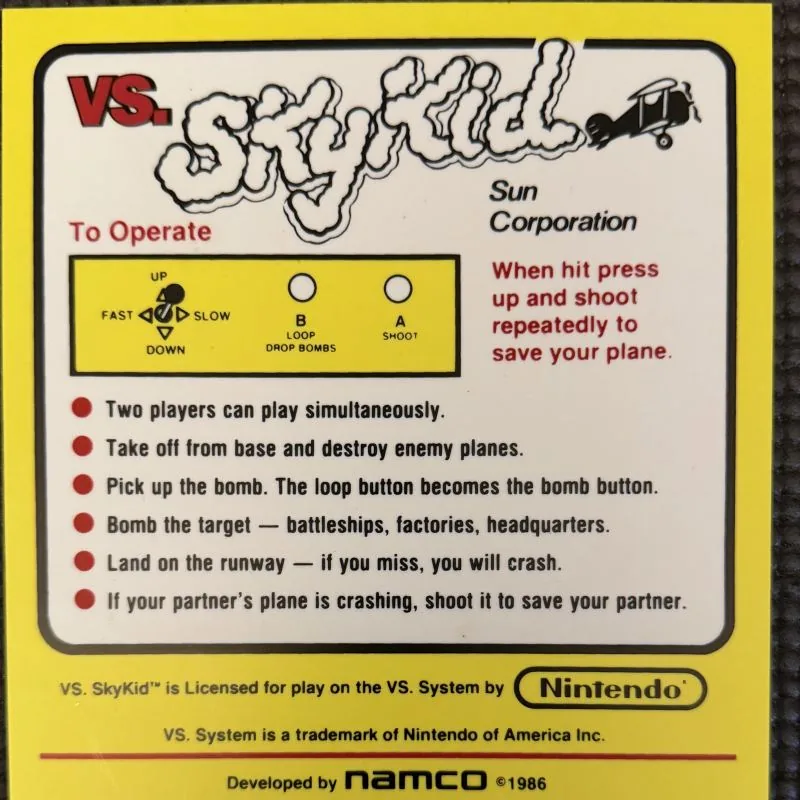 Nintendo VS. Sky Kid instruction card, bright yellow, with the Sky Kid logo and a biplane
